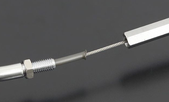 Metallic cable with a connector on a dark background