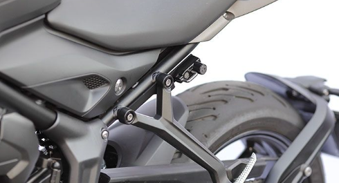 Close-up of a motorcycle's seat and rear area with a blurred background