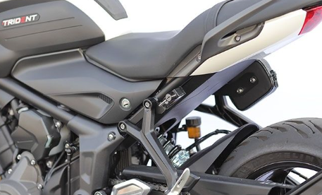 Close-up of a motorcycle seat and front wheel with 'Trident' branding.