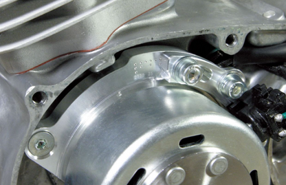 Close-up of a metallic engine component with bolts and metal parts.