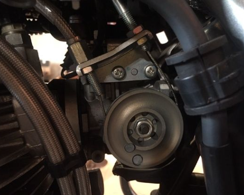 Close-up of a mechanical component with bolts and a pulley system.