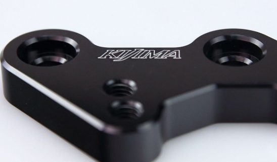 Black metal component with 'KJIMA' branding on a white background