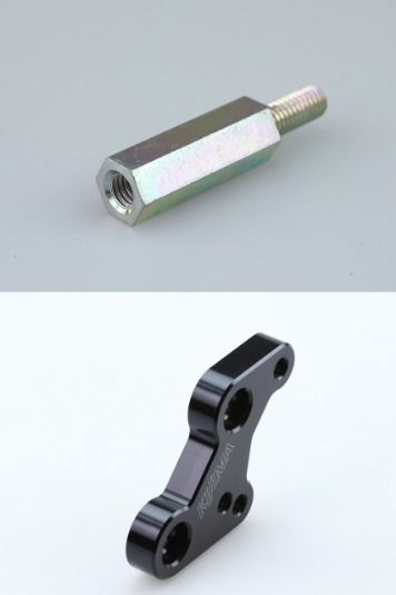 Metallic bolt and black mechanical component on a white background