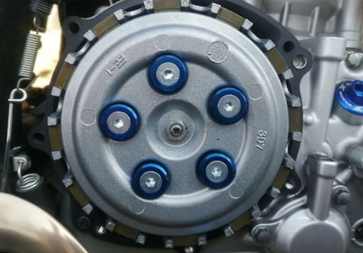 Close-up of a mechanical component with blue bolts on a metallic background