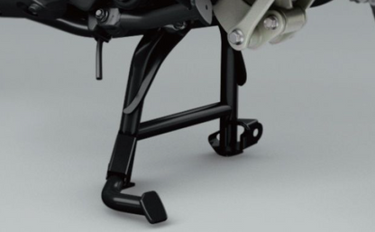 Close-up of a motorcycle's foot pegs on a gray background