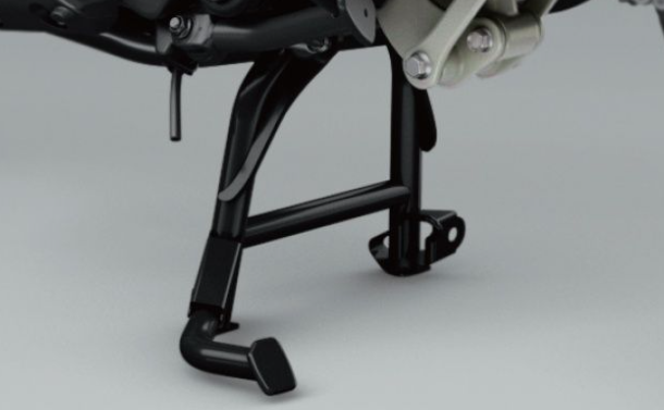 Close-up of a motorcycle's foot pegs on a gray background